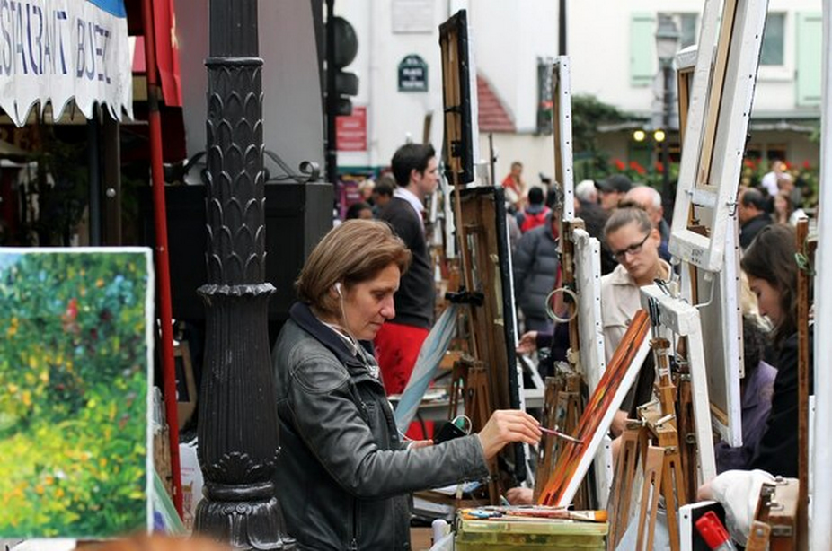 Individuals painting outdoors.